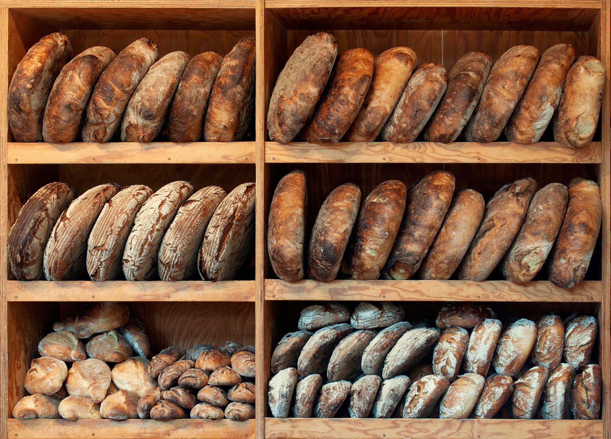 Shelves stocked with fresh artisan loaves